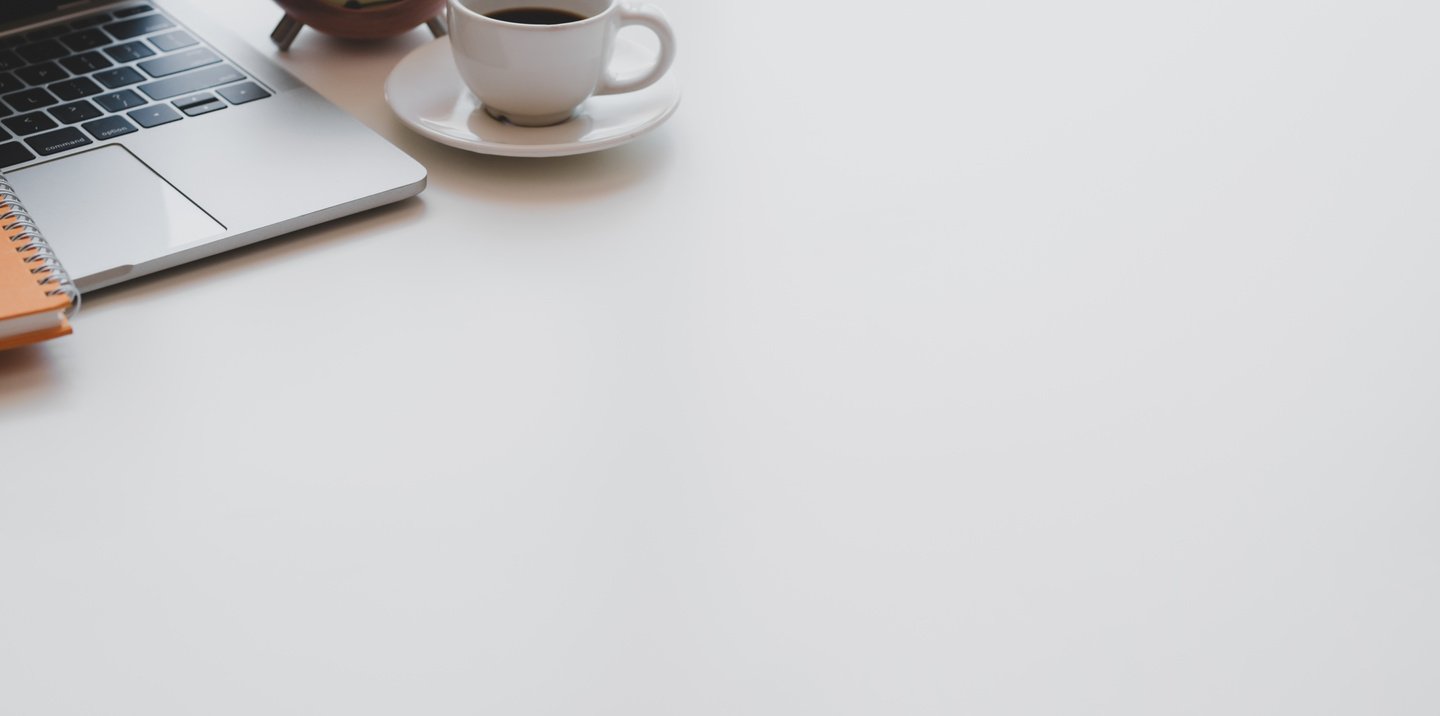 Netbook and coffee cup on desk